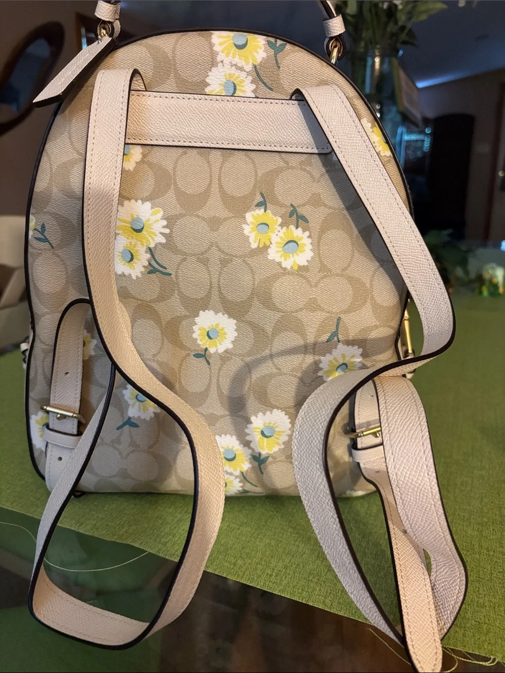 Coach Beige Signature Daisy Backpack with matching wallet.